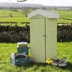 Thorndown-Rhyne-Green-Wood-Paint-on-Small-Storage-Shed-with-Trug-in-Cow-Parsley-White-and-Ottery-Brown-and-Crates-in-Brue-Blue-and-Launcherley-Blue