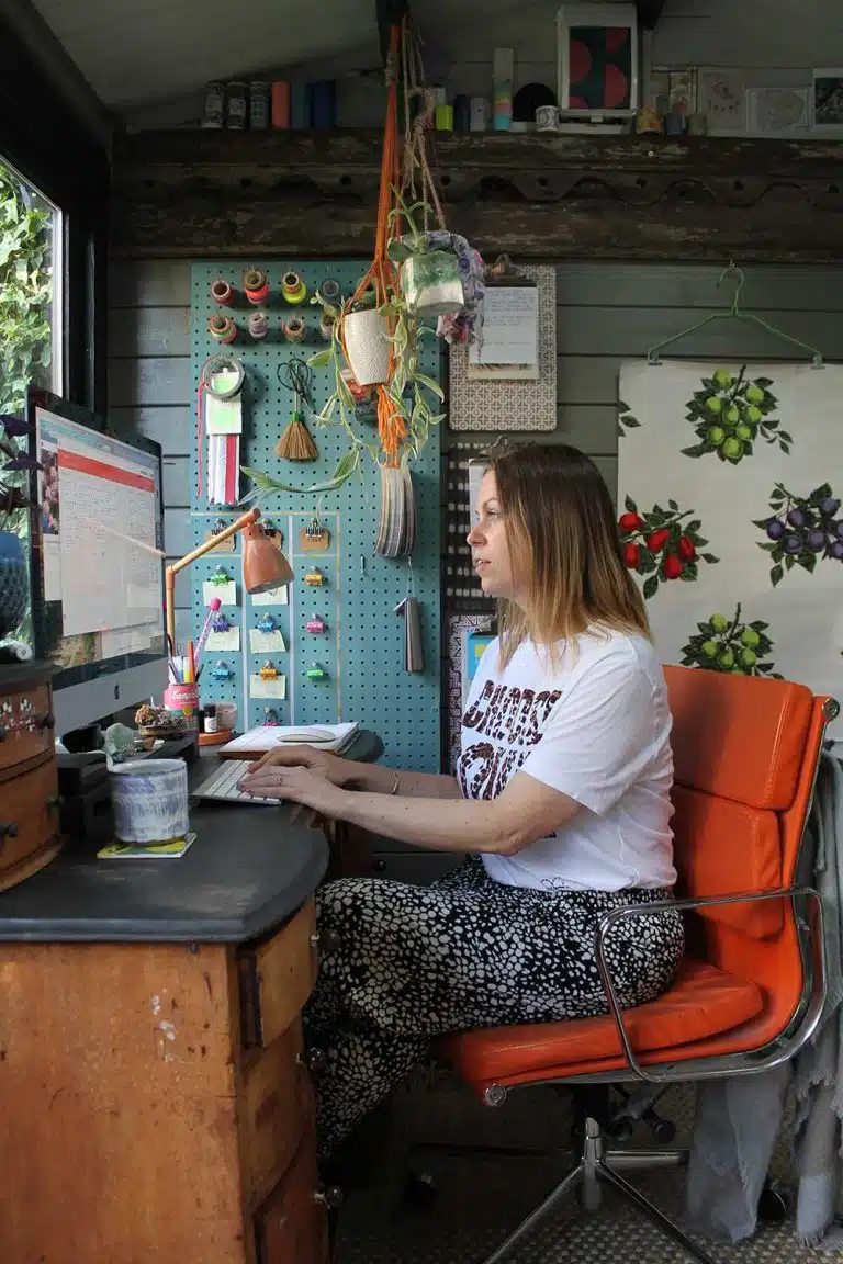 Joanna-Thornhill-Garden-Shedio-Interior-with-Jo-sat-in-Desk-Area-Portrait