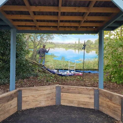 Jon-Minshull-painting-mural-with-Thorndown-Wood-Paint_pergola-in-Launcherley-Blue_Love-Your-Garden-Taunton