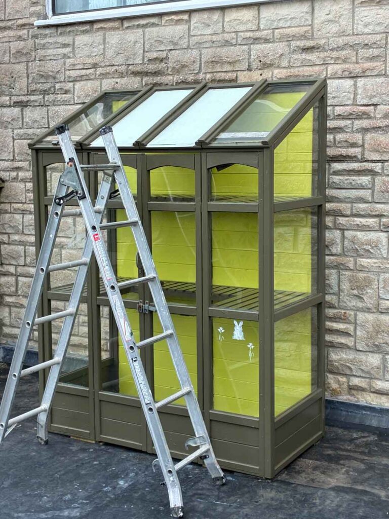 painting-fresh-coat-of-peelable-glass-paint-shading-paint-on-roof